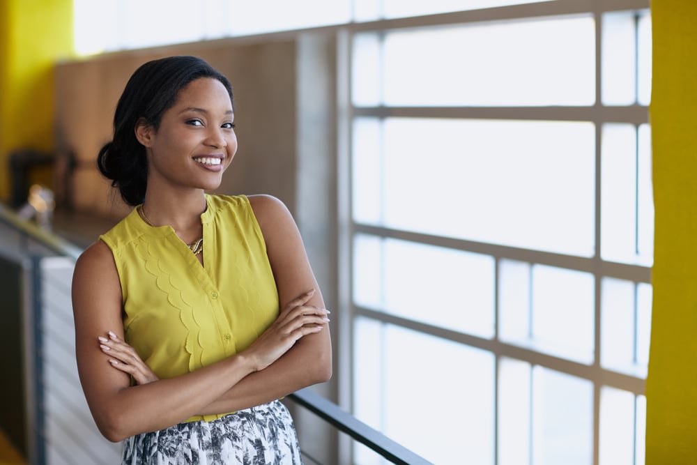 Confident businesswoman smiling in bright modern office