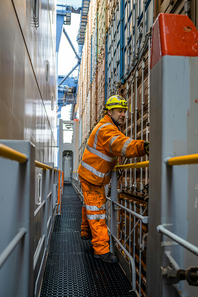 Warehouse professional standing near containers