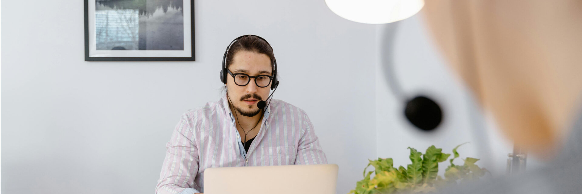 IT professional assisting a colleague at a computer