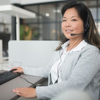 Support professional assisting a client on a computer