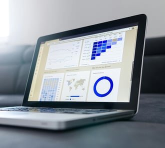 Professional reviewing real-time payment data on a laptop