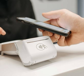 Person making a mobile payment on a smartphone