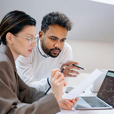 Finance and operations leaders reviewing documents together
