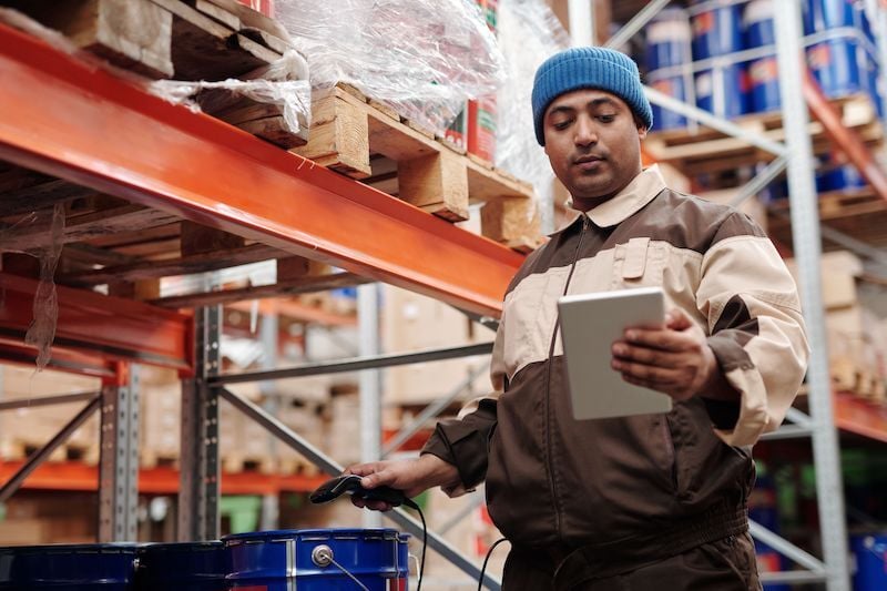 man on ipad in warehouse