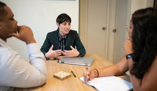 person with laptop speaking at meeting