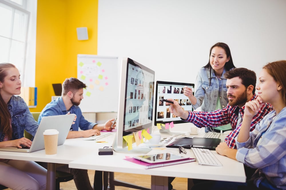 Business team working together on computer project