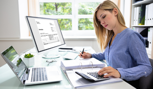 woman working on accounting at a desk